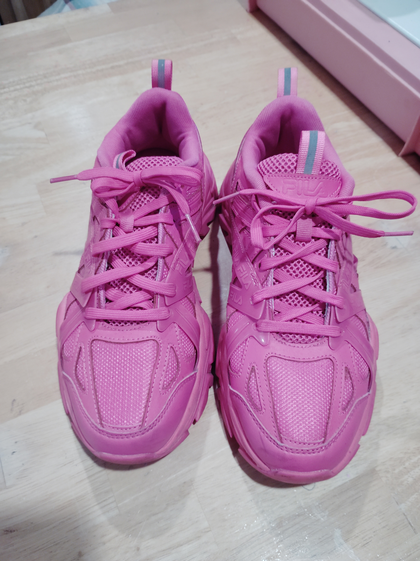 Hot pink Fila chunky sneakers from the Honey Badger's closet.